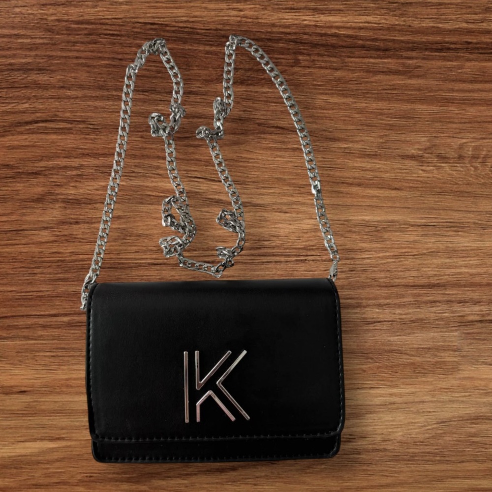 Stylish Black Crossbody Bag with Chain Strap and Flap Closure

KENDALL + KYLE